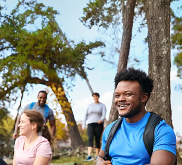 Chris, a real person with narcolepsy with cataplexy taking WAKIX, with friends outdoors